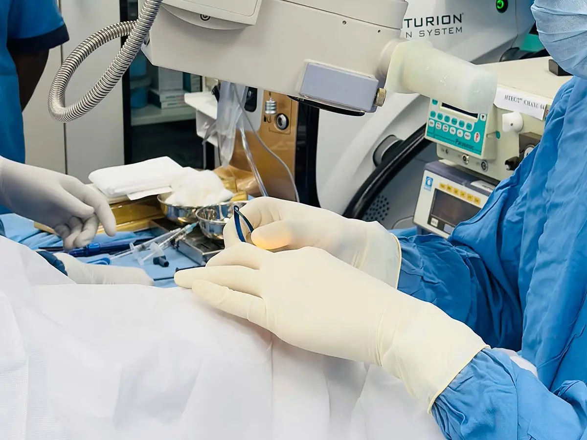 Surgeon wearing polyisoprene surgical gloves during a precision procedure