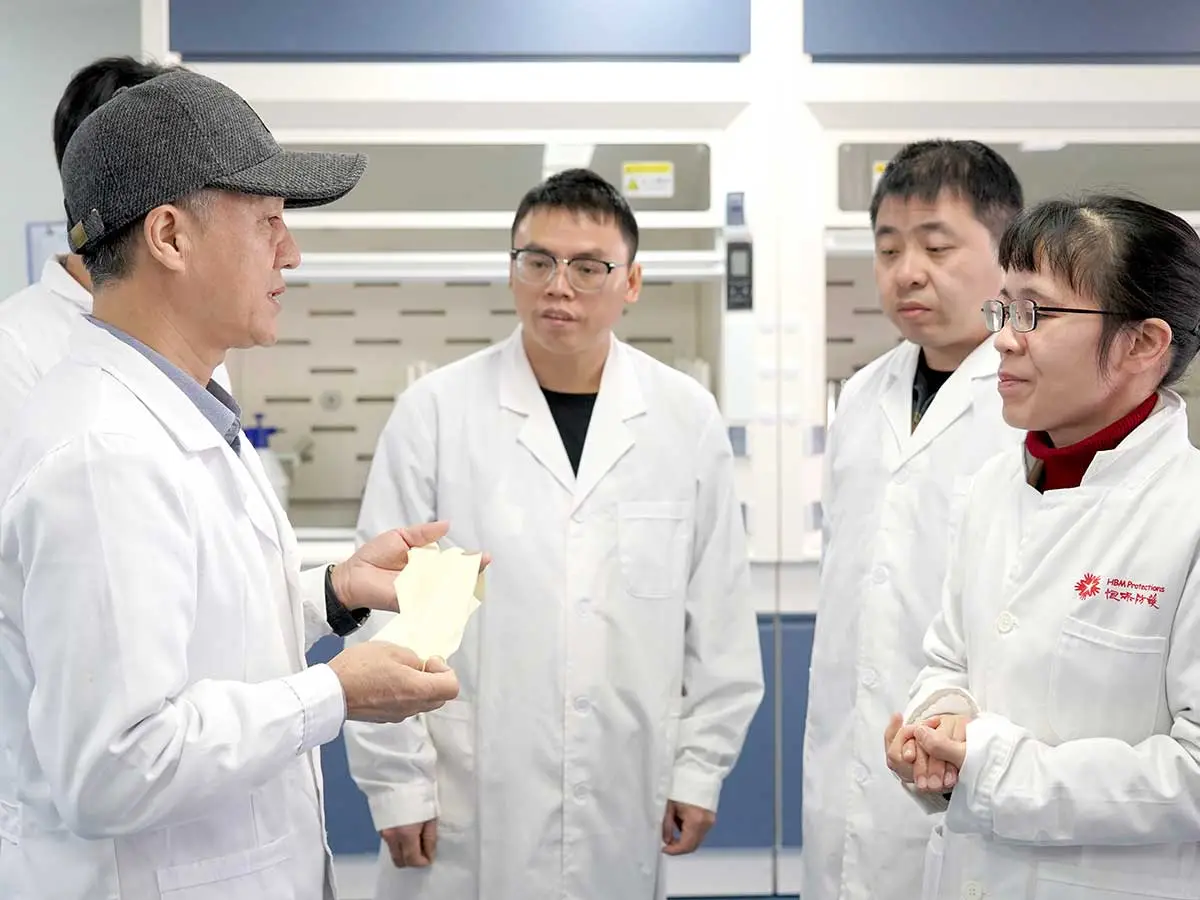 R&D experts discussing quality control in HBM Protections laboratory